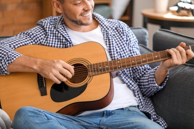 Adult playing guitar.