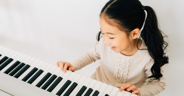 Young child on piano.