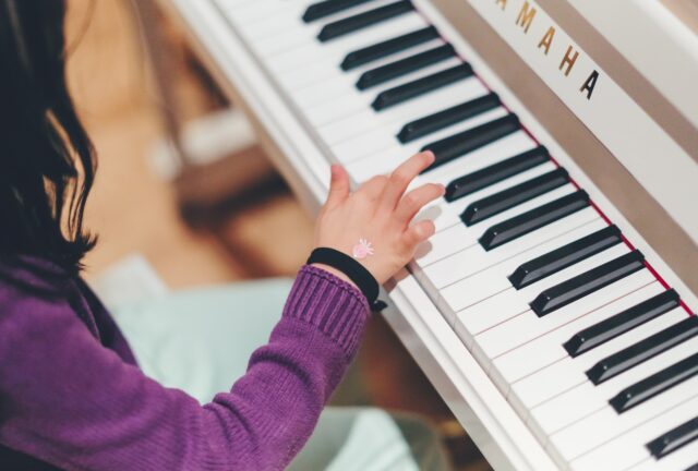 Young child playing the piano.