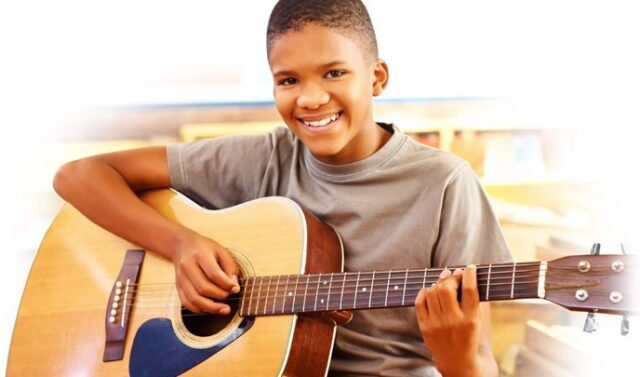 Boy taking guitar lessons